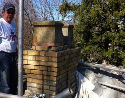 Repairman next to chimney